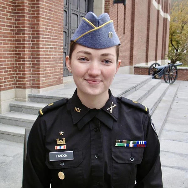 Emily Landon, a Norwich University cadet smiles in a headshot, wearing a Navy uniform