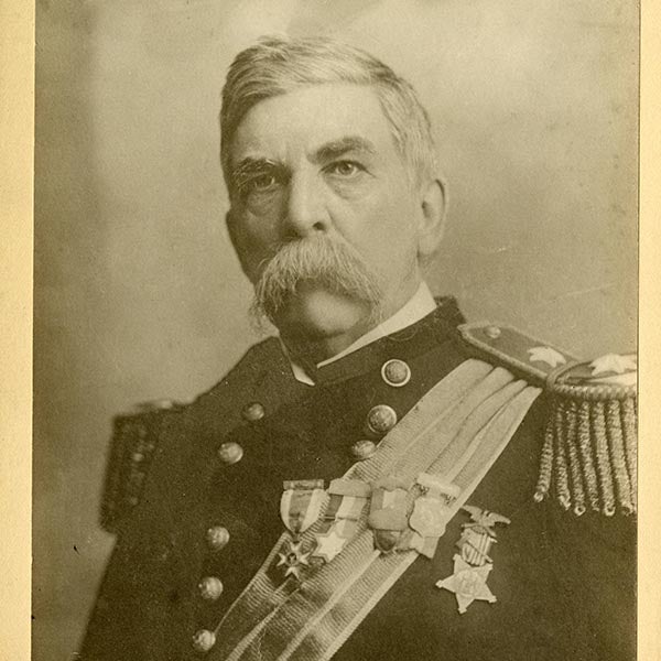 A service member in a decorated military uniform poses for a historical portrait.