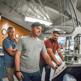 Norwich University Students working a CnC machine