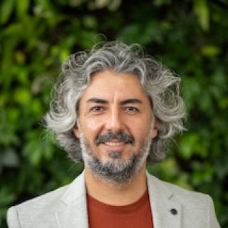 Cevat Dargin in suitcoat and orange shirt