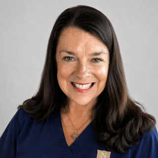 Person wearing navy Norwich University School of Nursing scrubs.