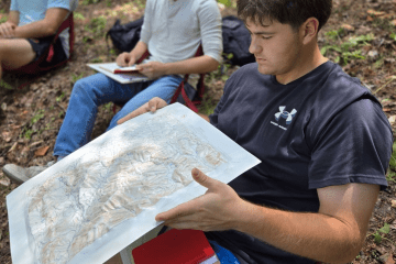 Three civilian students participating in an Outdoor School class at Norwich University