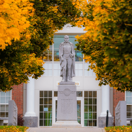 Capt. Alden Partridge statue surrounded by golden fall foliage.