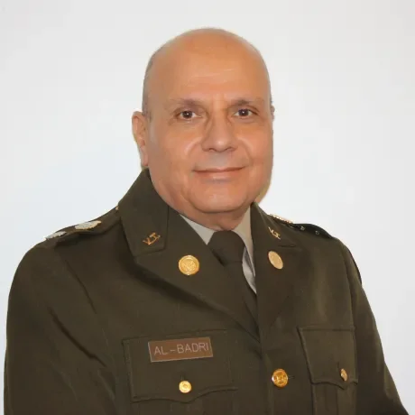 man with head shaved in uniform