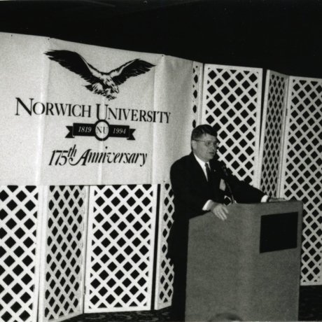 A black and white shot of a man at a podium during the Norwich University 175th Anniversary.