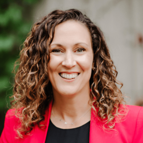 A woman smiles in a professional portrait headshot.