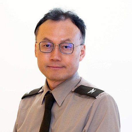 Yangmo Ku in uniform wearing glasses