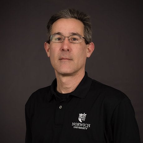 James Bernard with black norwich shirt and glasses