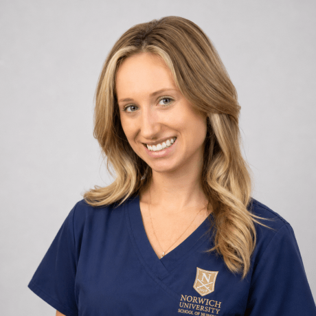 Person wearing navy Norwich University School of Nursing scrubs.