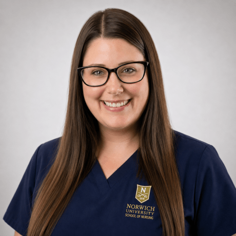 Person wearing navy Norwich University School of Nursing scrubs and glasses.