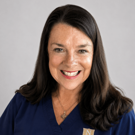 Person wearing navy Norwich University School of Nursing scrubs.