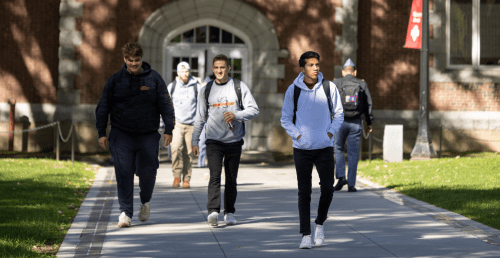Norwich University students walking across campus.