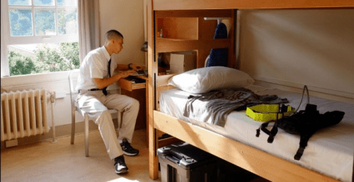 Rook at his desk inside the Norwich University barracks.