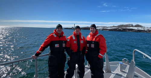 Norwich members of the AUP unit standing together on a ship.