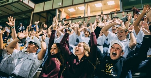 Students cheering for a Norwich team at the Harmon Stadium on Sabine Field.