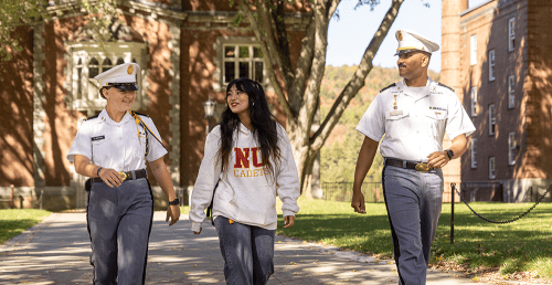 Two corps students and a civilian student walking together on campus.