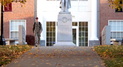 Norwich University Rook Walking On Campus on Fall Day