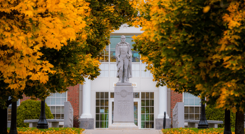 Capt. Alden Partridge statue surrounded by golden fall foliage.