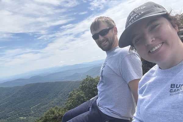 Ashleigh and husband on top of mountain