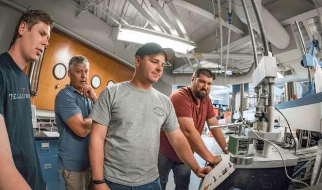 Norwich University Students working a CnC machine