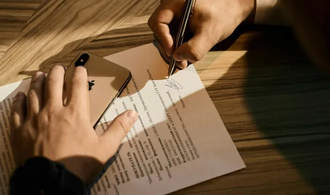 Hands signing document