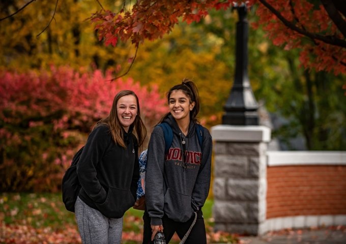 Norwich University civilian students with fall foliage.