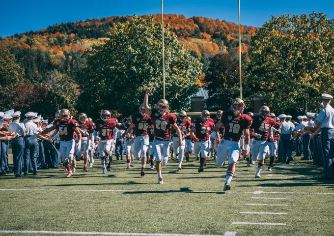 Norwich football players running onto Sabine field.