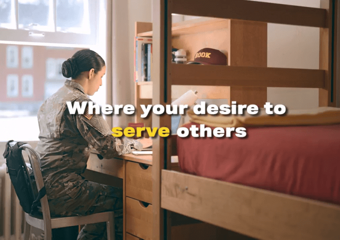 Corps student sitting at her desk in barracks.