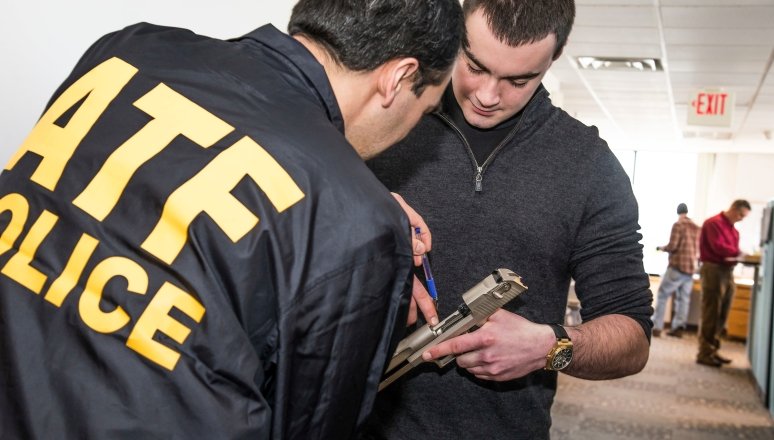 Norwich ATF Intern Inspecting Firearm