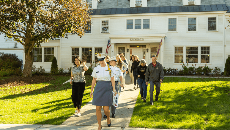 Norwich University students leading families on a campus tour outside the Roberts Hall Admissions Office.