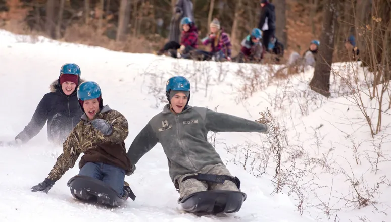 Shaw Outdoor Center Corps and Civilian students sledding