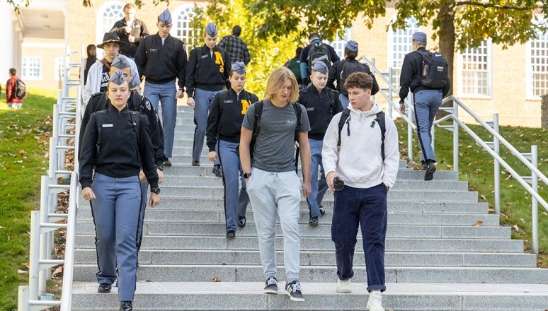 Students of all lifestyles walking on staircase on campus.