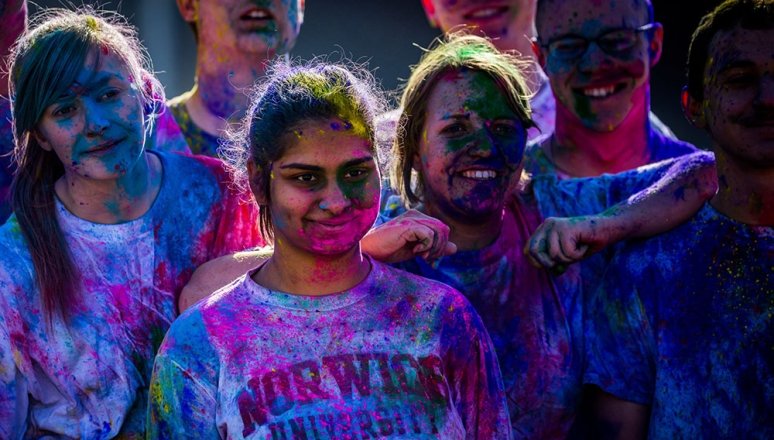 Students covered in paint during the campus Holi Festival.