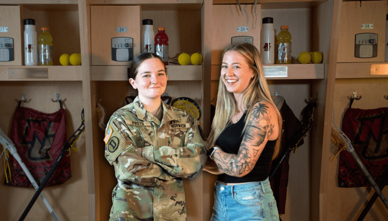 Corps and civilian student standing side by side.