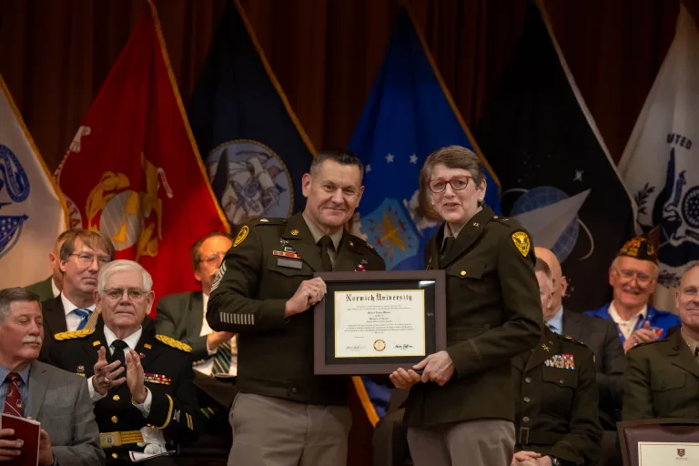 Norwich University Provost & Dean of the Faculty, and Acting President Dr. Karen Gaines presented SMA Michael Weimer with a special framed copy of his diploma from Norwich University
