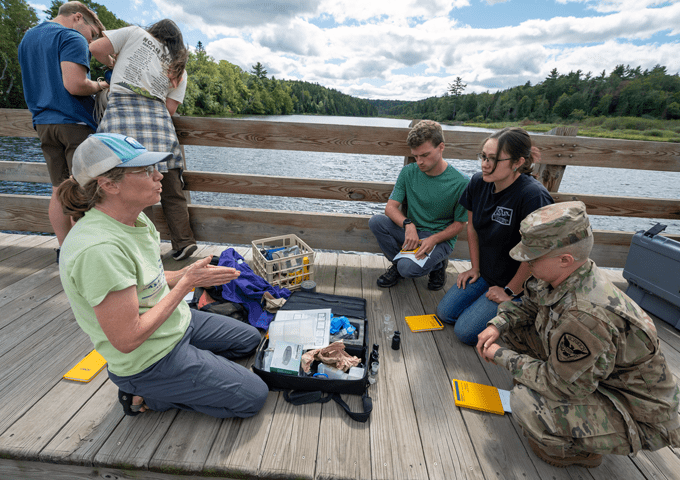 Norwich civil engineering students hands on learning outdoors with professor