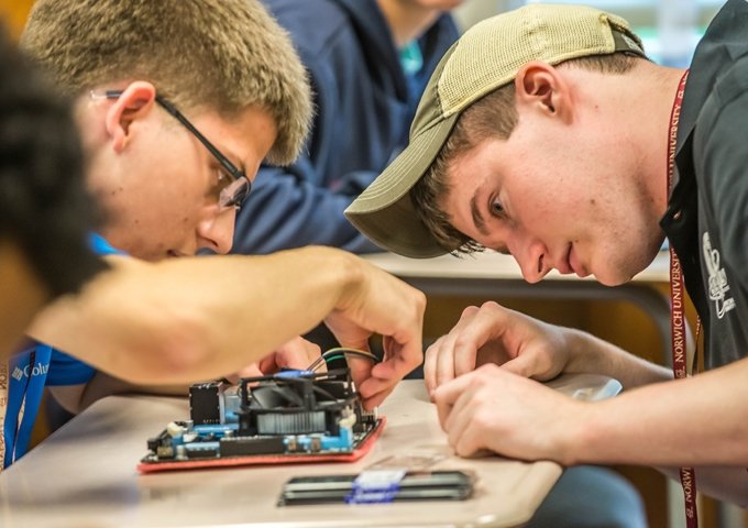 Norwich University Engineering students working on computer board