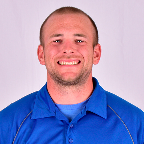 Person wearing a blue collared shirt over a blue T‑shirt.