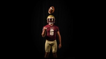 A football player poses for a marketing photo.