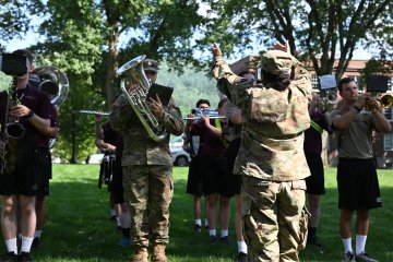 Norwich band and cadets rehearse outside.