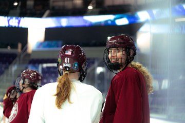 Norwich players in red and white jerseys chat during high-intensity practice drill 